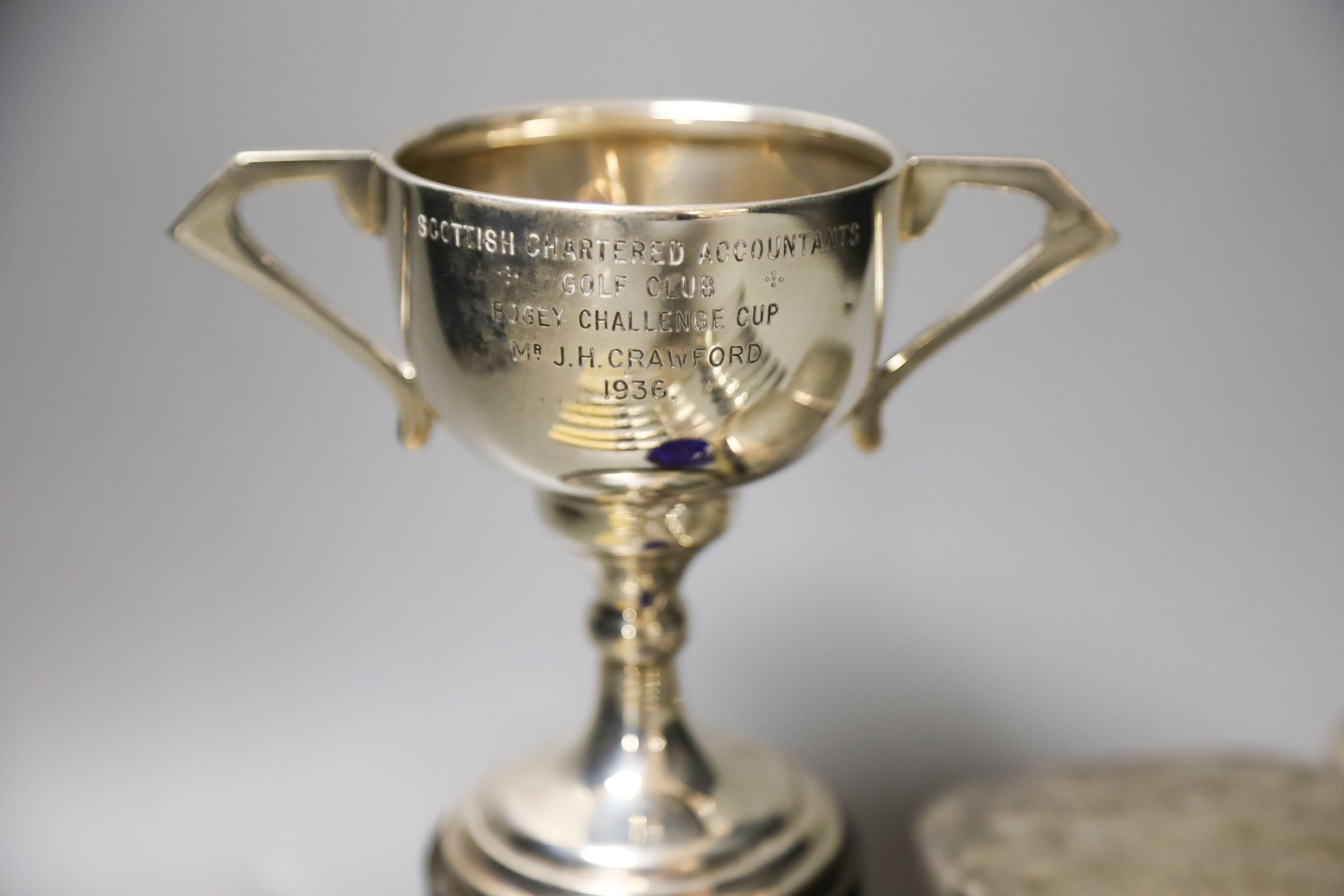 A pair of silver mounted clothes brushes, a silver two handled trophy cup and sundry flatware.
